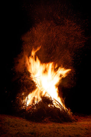 Big open fire at night on traditional festival in mountains. Bonfire at midsummerの写真素材
