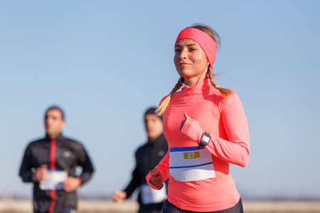 Young sporty woman running marathon competition