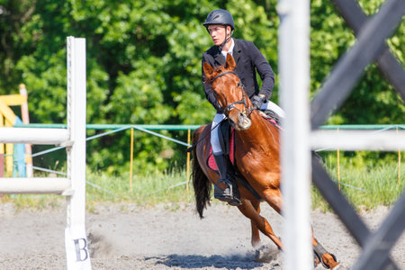 Young man on his course show jumping competitionの写真素材