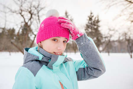Teenage girl enjoying winter season in the parkの写真素材