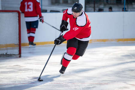 Professional ice hockey player in attack on the rinkの写真素材