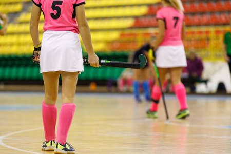 Young girl hockey player playing indoor hockeyの写真素材