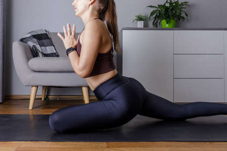 Young woman practicing yoga at home in the morningの写真素材