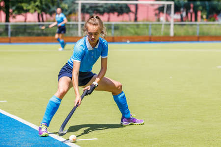 Young woman field hockey player performing corner penaltyの写真素材