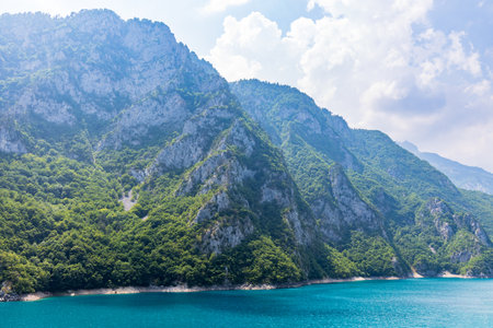 Landscape view of big lake between mountains at summer dayの写真素材