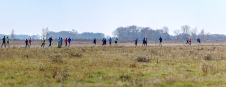 A large crowd is sprinting across the airstrip, taking part in a sporting event.の写真素材