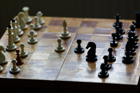 Strategic chess match in a quiet room showcasing black and white piecesの写真素材
