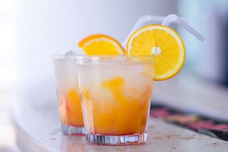 Refreshing citrus cocktails served with orange slices and a strawの写真素材