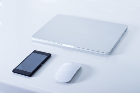 Open laptop with black smartphone . Horizontal orientation.の写真素材