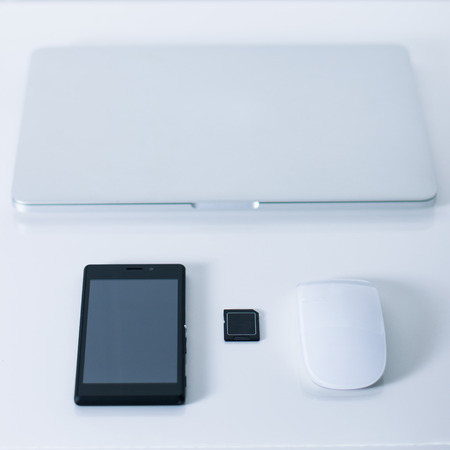 Open laptop with black smartphone . Vertical orientation.の写真素材