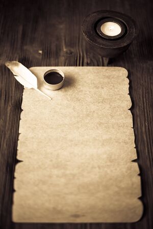 old paper on brown wood texture with feather and inkの写真素材