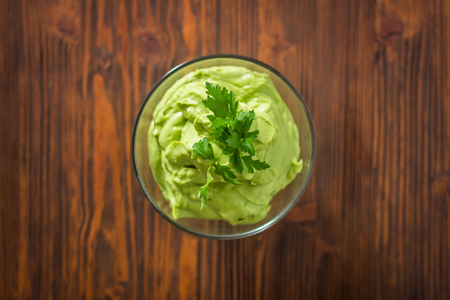 Guacamole on wooden tableの写真素材