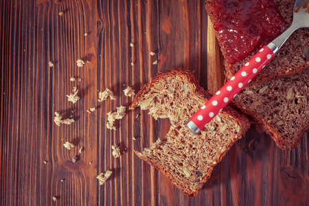 Wholemeal bread with apricot jam surrounded by dry fruit. Vintage/Retro style.の写真素材