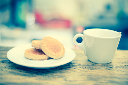 Tasty biscuit and coffee on wooden table. Selective focusの写真素材