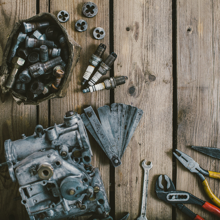 Carburetors for a car engine with tools on wooden tableの写真素材