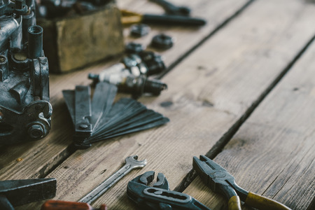 Carburetors for a car engine with tools on wooden tableの写真素材