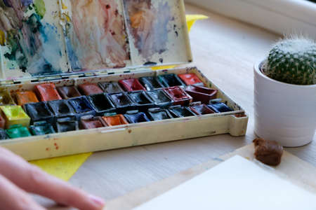 woman painting in watercolors at her workplaceの写真素材