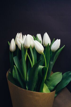 white tulips bouquet on a dark backgroundの写真素材