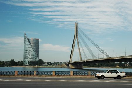 Capital of Latvia - Riga - riverside in summer with modern bank building and bridge over river.