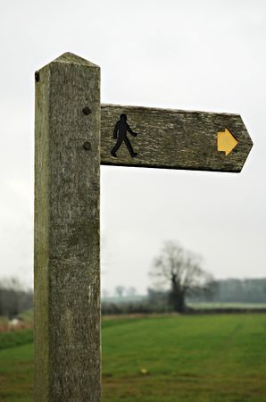 old wooden roadsign with arrow and man silhouette.
Easy to isolate.の写真素材
