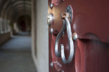 Beautiful door handle hanging on the red temple door 