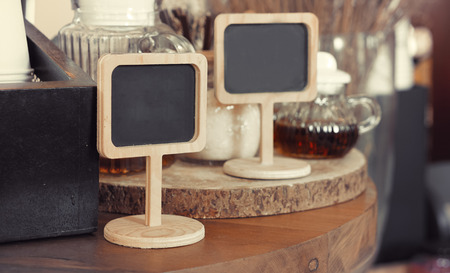 Small chalkboards on table in cafe or coffee shop, close upの写真素材
