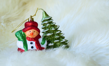 Small Snowman and Christmas tree on white fur, Christmas tree decorative ornamentsの写真素材