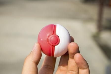 Thailand - August 20, 2016: Poke ball in Hand  (Pokemon Ball). Pokeball toy of the game Pokemon Go at Chon Buri, Thailand.のeditorial素材