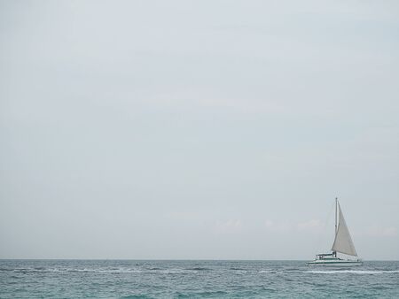 sailboat in blue sea with clouds sky background in Thailand. Relaxing moments in summer seasons travel. Tropical nature in vacation time.の写真素材