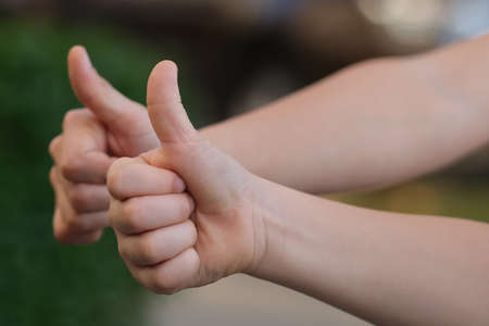Thumbs up as a gesture of positive agreement.