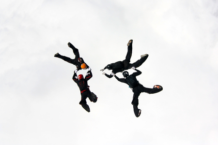 Team of four skydivers are training above the clouds.のeditorial素材