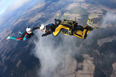 Two skydive instructors and students in the sky.の写真素材