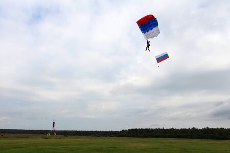 Skydiver with russian flag is landing.の写真素材