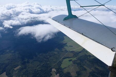 A wing of aiplane. The view from an opened door.