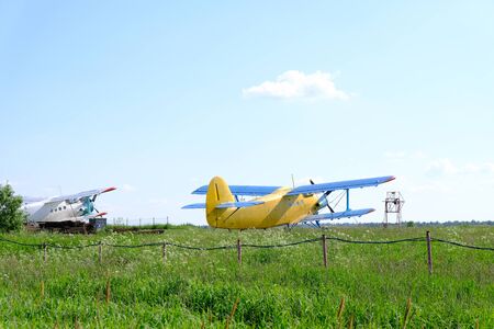 An small biplane is at an aerodrome.の写真素材