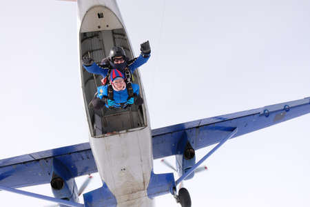 Skydiving. Tandem jump. Man and woman. WInter seasonの写真素材