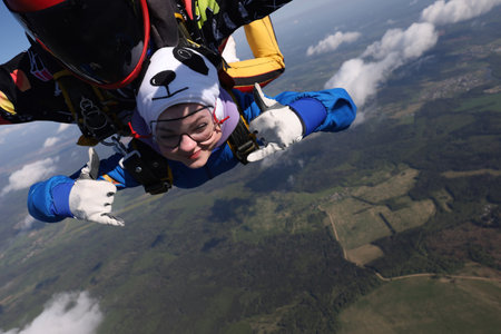 Skydiving. Tandem jump. A pretty girl and her instructor.のeditorial素材