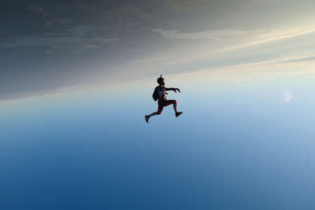 Skydiving. Freefly jump. A girl is having fun in the sky.
