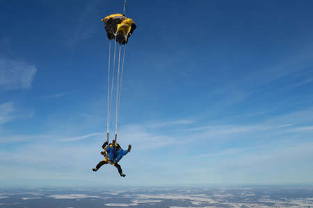Skydiving. Tandem jump. Two guys are in the sky.の写真素材