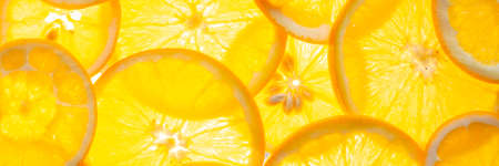 Round slices of fresh juicy orange on a luminous light surface. Healthy food conceptの写真素材