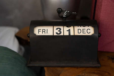 Black vintage calendar with bird with the last day of the year on the bedside table. The concept of waiting for the new year and saying goodbye to the outgoing yearの素材 [FY310179554085]