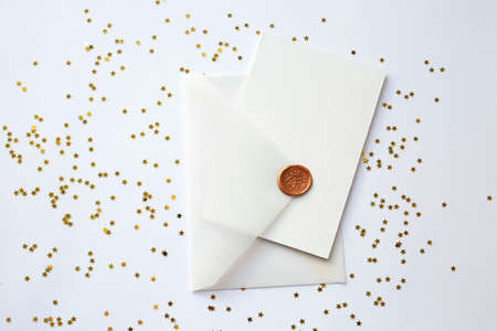 background with a transparent envelope and a white card on a festive background with gold sparkles in the form of a heart. Christmas gift and congratulations concept. flat layの写真素材