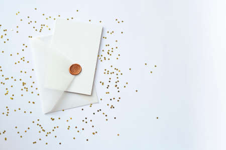background with a transparent envelope and a white card on a festive background with gold sparkles in the form of a heart. Christmas gift and congratulations concept. flat layの写真素材