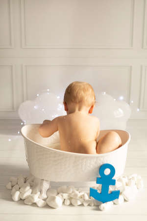 cute baby sitting in the milk bath