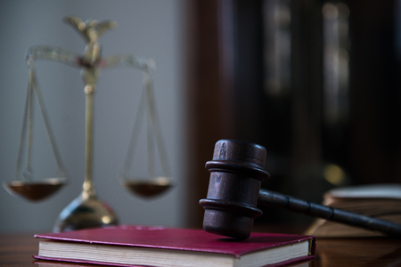 Gavel and legal book on wooden table, court room conceptの写真素材
