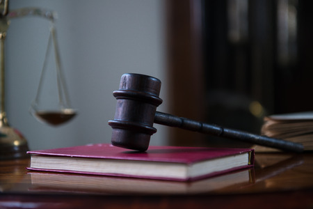Gavel and legal book on wooden table, court room concept