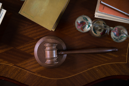Wooden gavel and books on wooden table, law conceptの写真素材