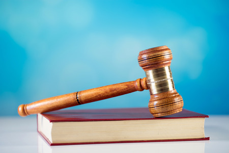 Judge gavel, scales of justice and law books in court