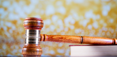 Law theme, mallet of the judge, wooden desk, books