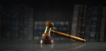 Law and Justice theme, mallet of the judge, wooden desk, books
